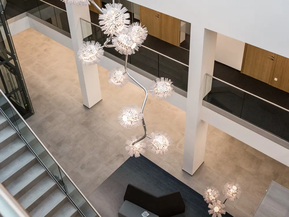 Moderne Raum mit stilisierten Deckenleuchten, Treppen und minimalistischer Einrichtung