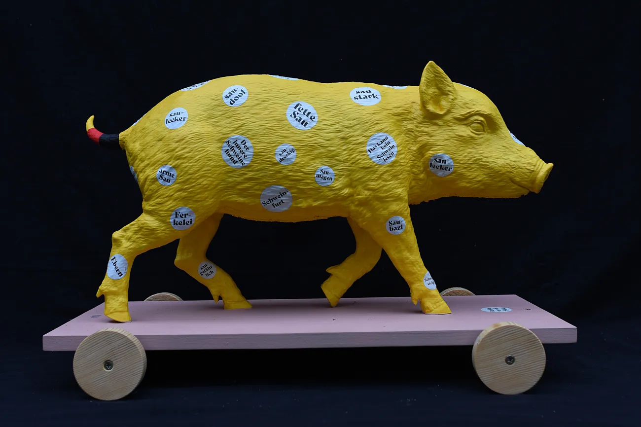 Gelbes Schwein steht auf rosanem Skateboard