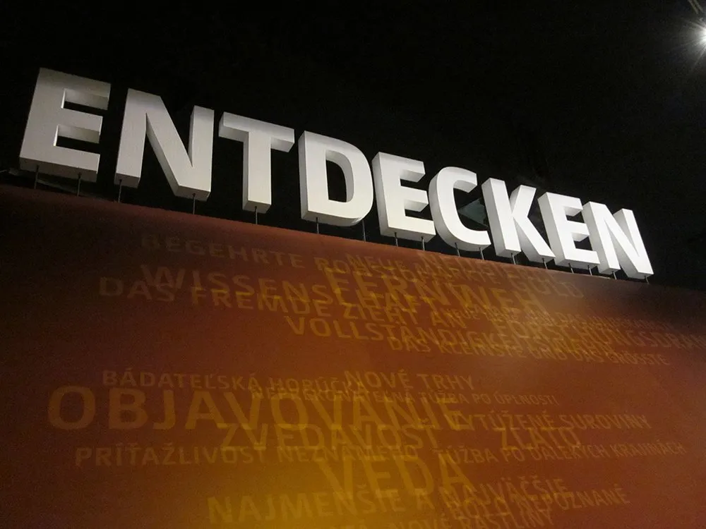 3D Schrift "Entdecken" über Wand platziert